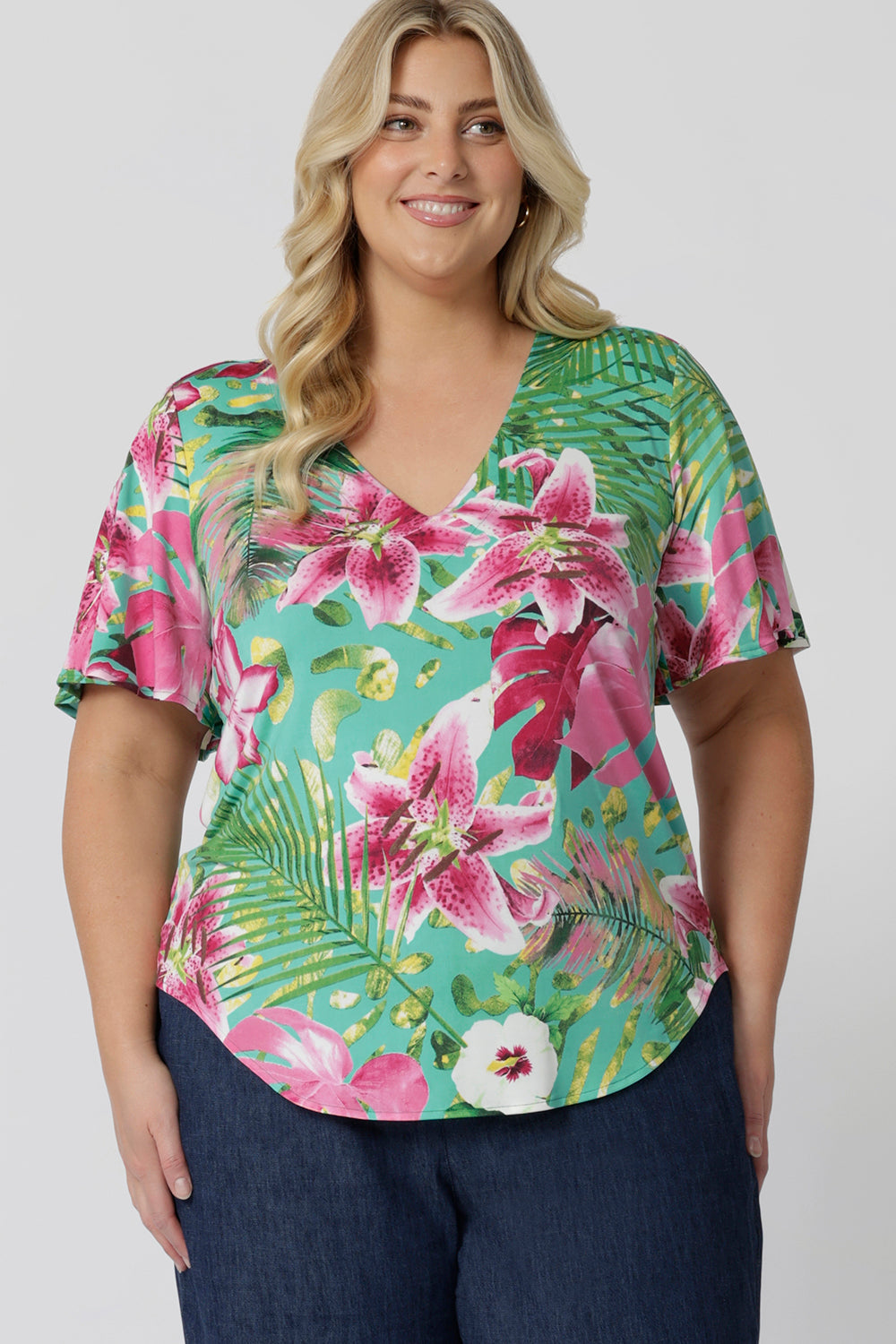 Plus sized model wears easy care top. This on-the-go style is Australian made using slinky jersey fabric. Travel ready top is perfect for any summer occasion. This top effortlessly elevates your style while keeping you comfortable in the summer months. Clothing brand Leina & Fleur stocks sizes 8-24.