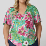 Plus sized model wears easy care top. This on-the-go style is Australian made using slinky jersey fabric. Travel ready top is perfect for any summer occasion. This top effortlessly elevates your style while keeping you comfortable in the summer months. Clothing brand Leina & Fleur stocks sizes 8-24.