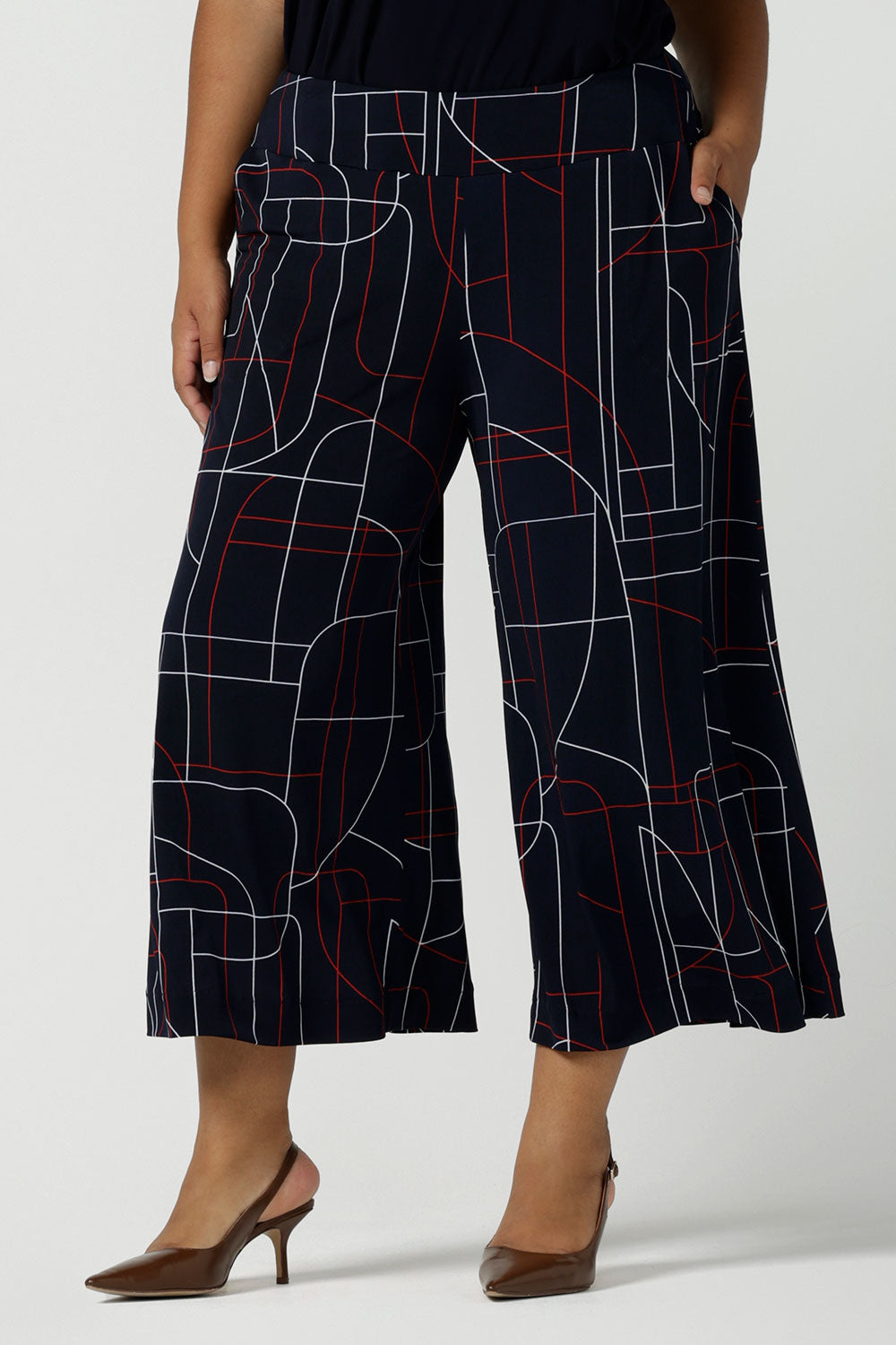 Close up of a size 16 woman wears the Dany Culotte in Navy Abstract. Corporate comfortable pant for women, geometric print with navy, red and white. Made in Australia for women size 8 - 24.