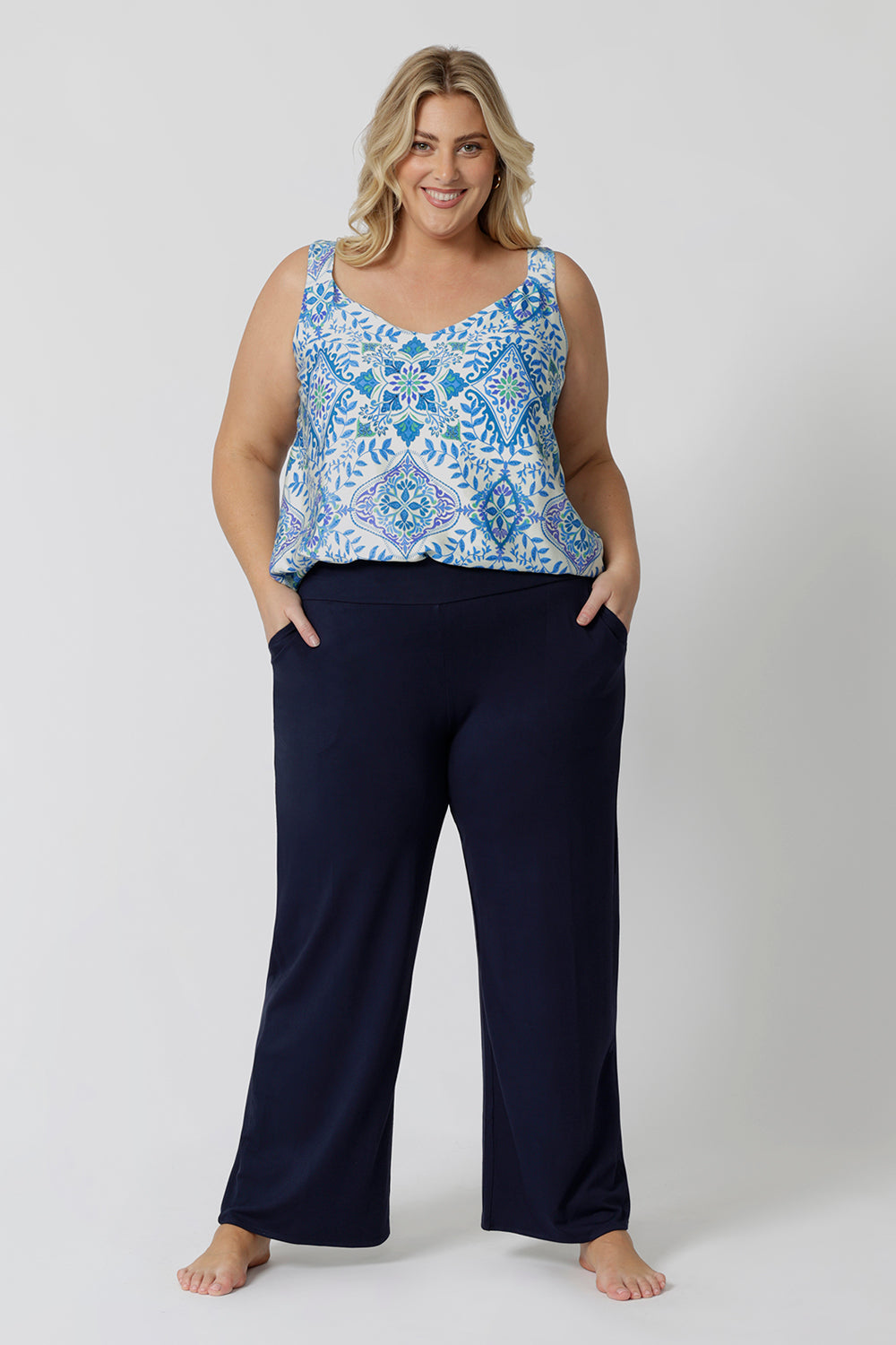 A good sleep and loungewear top for plus size women, a size 18 woman wears this blue ,white and green print cami top with wide shoulder straps. In eco-friendly modal fabric this top is breathable and thermo regulating and a good top for night  sweats. Creating the perfect pajama set, wear this cami top with bamboo jersey lounge pants.