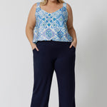 Showing good lounge pants for curvy women, a size 18 wears straight, wide leg navy blue, plus size lounge pants in bamboo jersey with a blue and white print modal cami top. Breathable and thermo-regulating this is a good pyjama set  for night sweats and hot flushes. Stay cool this summer nights with breathable sleepwear by L&F Australia.