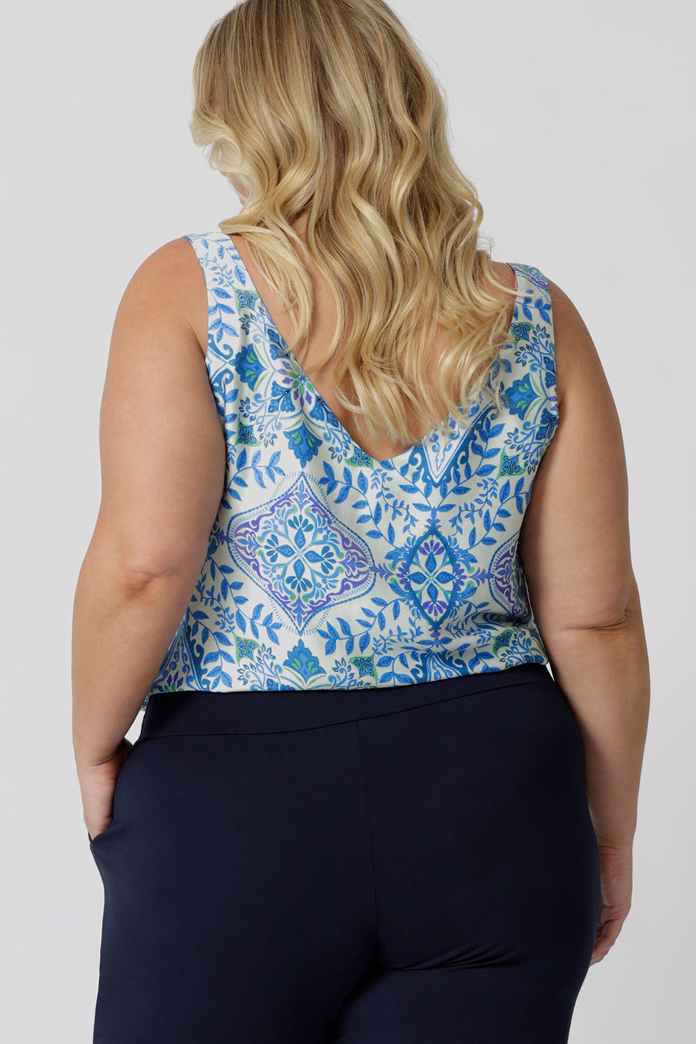 Back view of a good sleep and loungewear top for plus size women, a size 18 woman wears this blue ,white and green print cami top with wide shoulder straps. In eco-friendly modal fabric this pyjama top is breathable and thermo regulating and a good top for night  sweats. Create the perfect pajama set with this cami top and matching pyjama bottoms for women. 