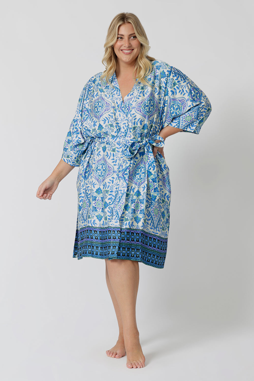 Lounge and Sleepwear robes for curvy women don't get much better than this! A size 18 woman wears a plus size lounge robe in blue and white print with belt tie. This modal dressing gown is breathable and therm-regulating, making it a dressing gown to keep you cool when getting ready and also a good sleepwear robe for night sweats and hot flushes. Shop robes online as part of women's fashion brand, L&F's new lounge and sleepwear wear range for women. 