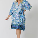 Lounge and Sleepwear robes for curvy women don't get much better than this! A size 18 woman wears a plus size lounge robe in blue and white print with belt tie. This modal dressing gown is breathable and therm-regulating, making it a dressing gown to keep you cool when getting ready and also a good sleepwear robe for night sweats and hot flushes. Shop robes online as part of women's fashion brand, L&F's new lounge and sleepwear wear range for women. 