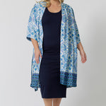 Lounge and Sleepwear robes for curve women don't get much better than this! A size 18 woman wears a plus size lounge robe in blue and white print with navy blue bamboo jersey midi dress. This modal dressing gown is breathable and thermo-regulating, making it a dressing gown to keep you cool when getting ready and also a good sleepwear robe for night sweats and hot flushes. Shop robes online as part of women's fashion brand, L&F's new lounge and sleepwear wear range for women. 