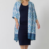 Lounge and Sleepwear robes for curve women don't get much better than this! A size 18 woman wears a plus size lounge robe in blue and white print with navy blue bamboo jersey midi dress. This modal dressing gown is breathable and thermo-regulating, making it a dressing gown to keep you cool when getting ready and also a good sleepwear robe for night sweats and hot flushes. Shop robes online as part of women's fashion brand, L&F's new lounge and sleepwear wear range for women. 