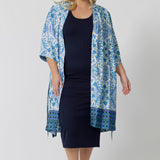 Worn with a blue and white print women's dressing gown , this navy blue lounge dress works as a nightdress and as loungewear. Shown on a size 18 woman, this slim-fit, plus size midi-dress in navy blue bamboo jersey is breathable and thermo-regulating. A good dress for night sweats and hot flushes, wear this as a summer dress for warm summer days. Shop nightdresses in women's clothes brand, L&F's new loungewear and sleepwear range online in sizes 8 to 24.