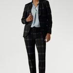 Lulu brings a sleek, modern edge to both workwear and smart-casual styling. This versatile pant is part of the Cocoa Plaid collection, a striking suiting range in a deep navy and graphite check. Size 10 woman wears her tailored pant with ice blue coloured blouse and matching plaid blazer.