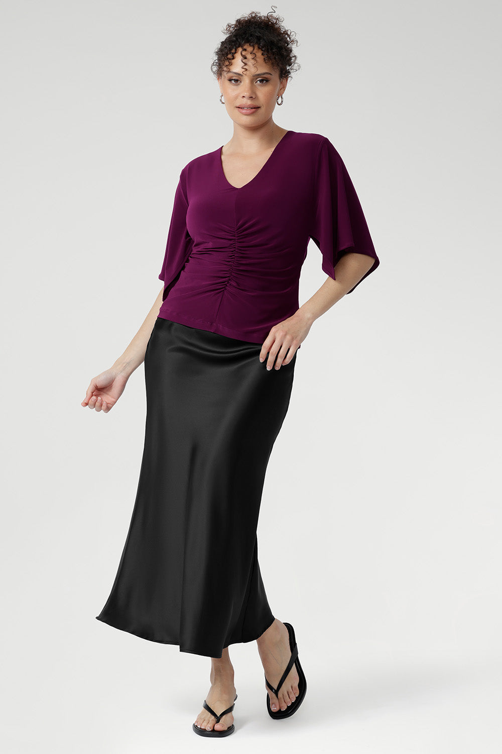The Luna Top is expertly crafted from our signature dry-touch stretch jersey, offering a perfect balance of professional style and all-day comfort. This elegant top features a flattering V-neckline that adds a touch of sophistication, while the unique handkerchief sleeves bring a modern, feminine edge to your wardrobe. Designed with subtle bust darts for enhanced fit and a clean straight hemline for a polished silhouette.