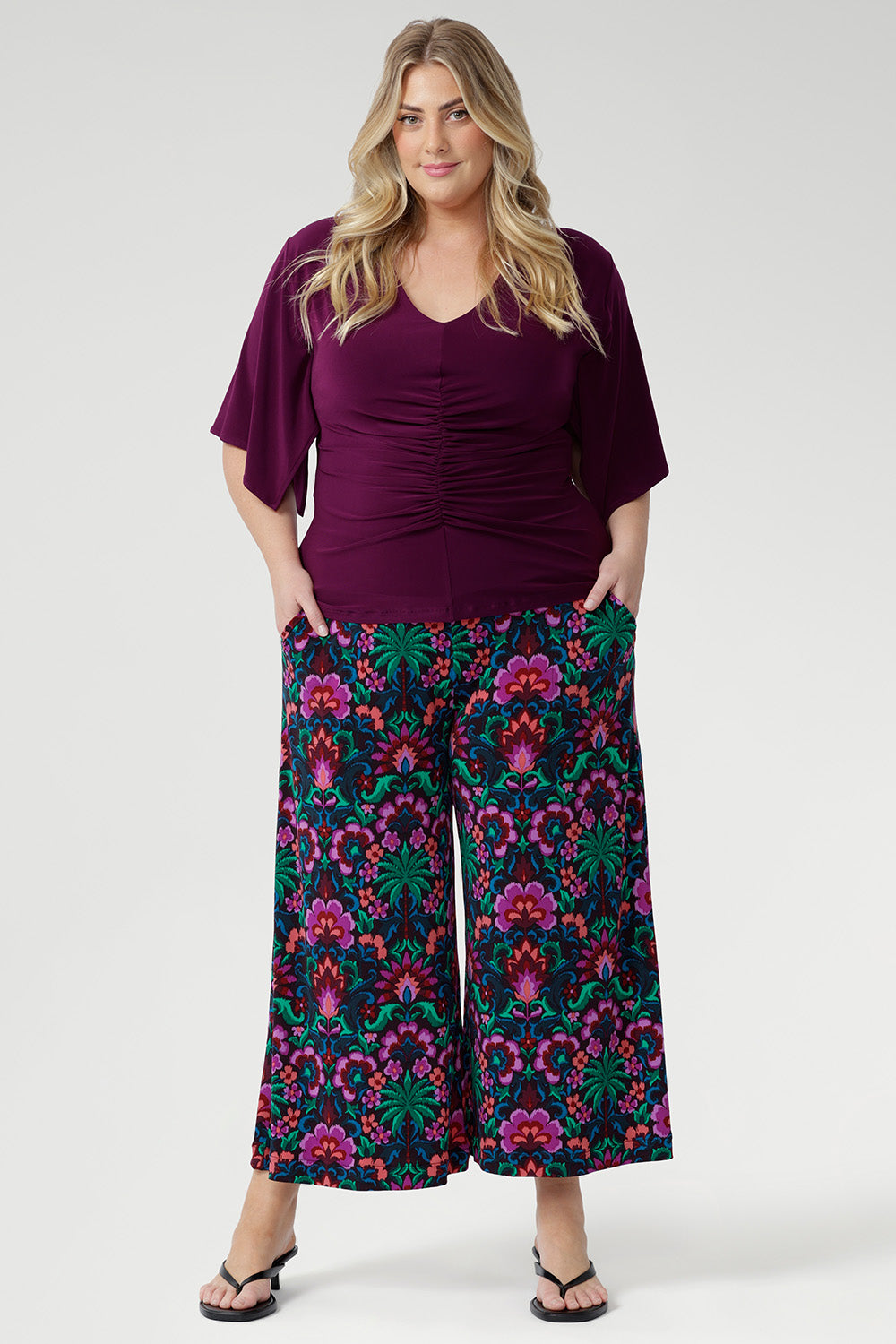 Designed with subtle bust darts for enhanced fit and a clean straight hemline for a polished silhouette, the Luna Top is a versatile staple for any work-to-weekend wardrobe. Plus size model wears her Luna Top with printed culottes.