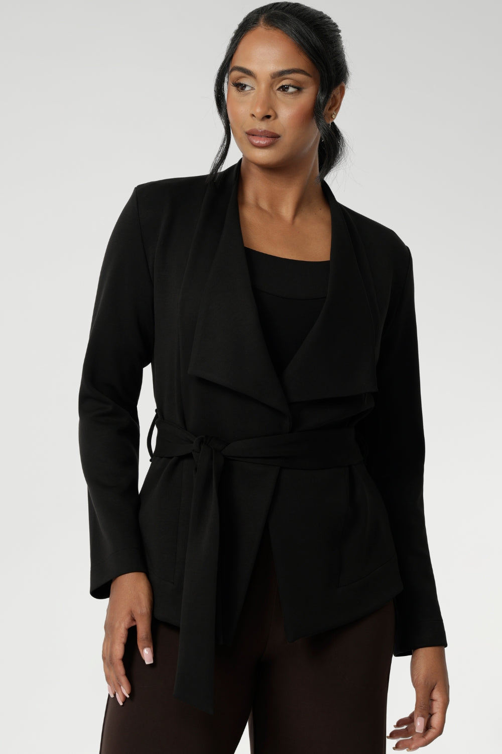 Lyndon features a double-layer jacket with   angled front panels for a modern edge and a detachable waist tie with belt loops, allowing you to wear it open or cinched to define your silhouette. Available in size 8-24. 