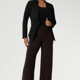 Sophisticated, versatile, and made to flatter — the Lyndon Jacket blends comfort and elegance. Size 10 model wears her Lyndon Jacket in Black with Brown wide leg Pants and Black Ballet Flats. 