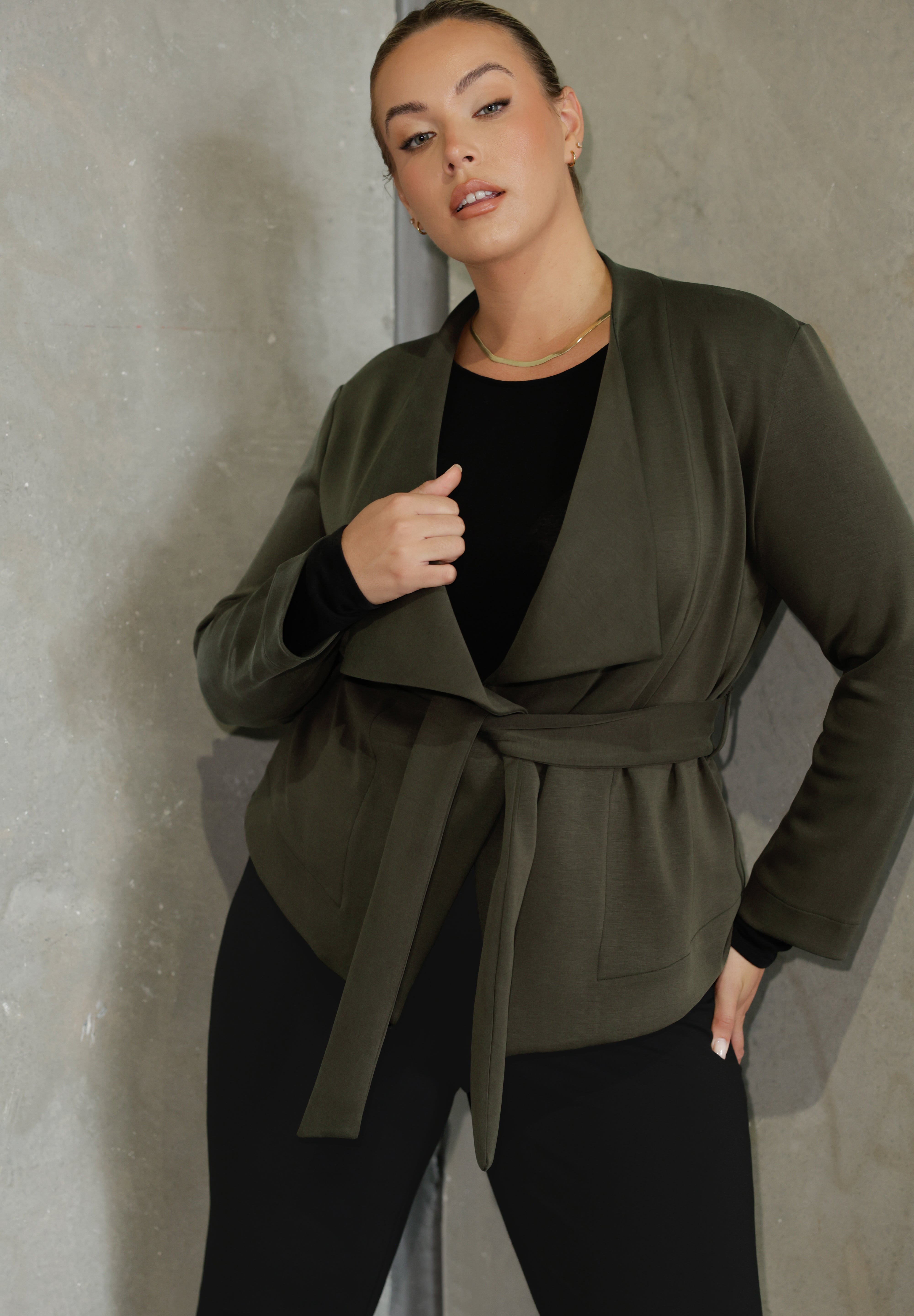 Lyndon features a double-layer jacket with   angled front panels for a modern edge and a detachable waist tie with belt loops, allowing you to wear it open or cinched to define your silhouette. 
