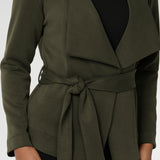 Designed in a flattering wrap style, it features double-layered, angled front panels for a modern edge and a detachable waist tie with belt loops, allowing you to wear it open or cinched to define your silhouette. 