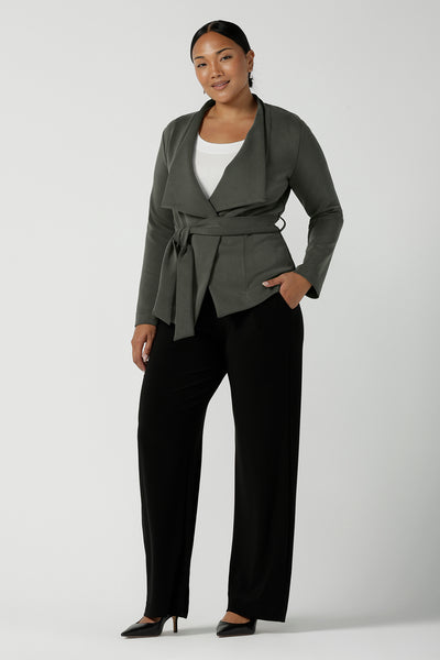 Woman wears the Lyndon Jacket in sage, a modal style collared jacket. Styled back with a black Monroe pants and a white bamboo top. Made in Australia for women size 8 - 24.