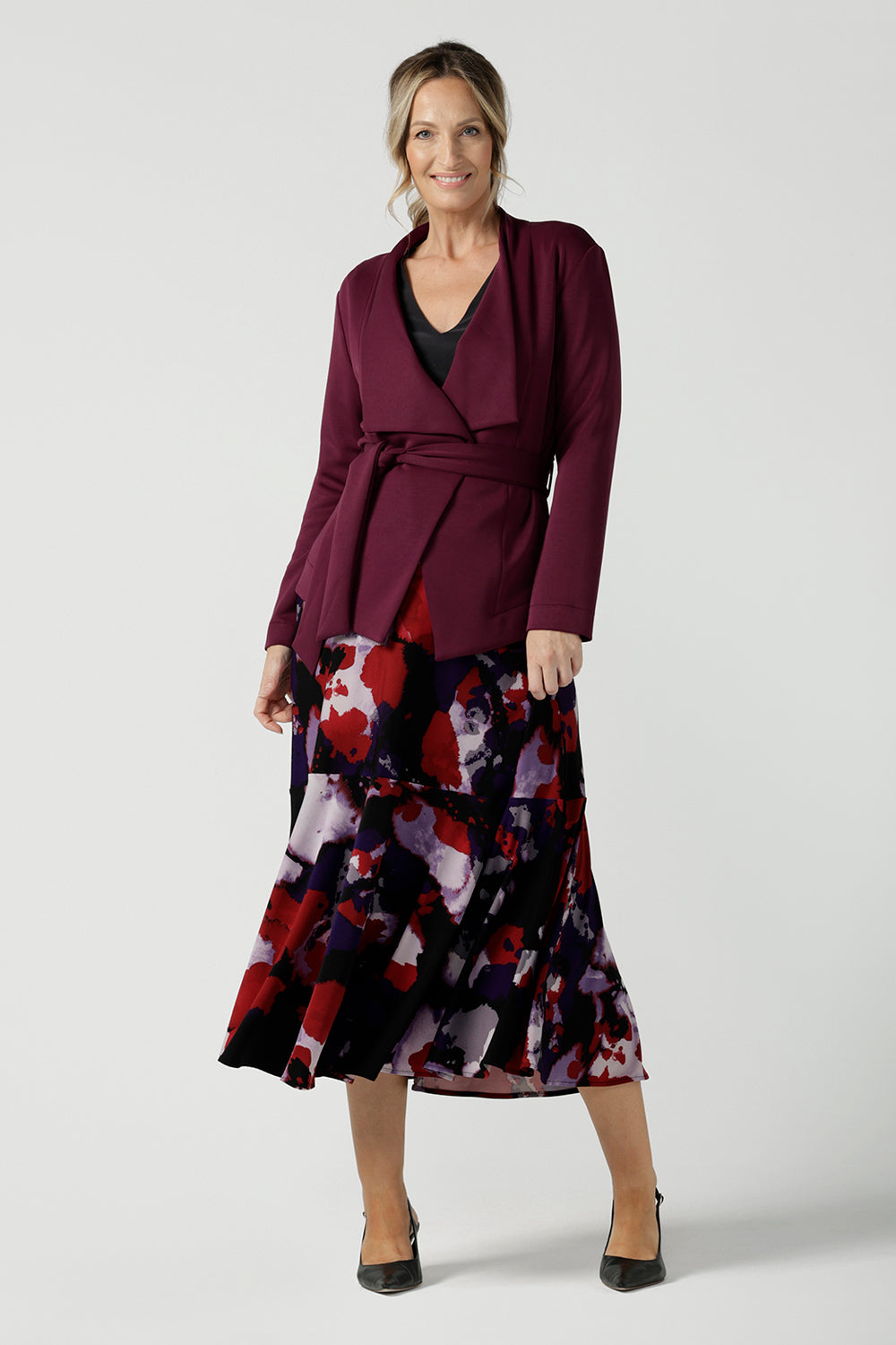 Size 10 woman wears the Lyndon Jacket in Wine a made in Australia jacket in comfortable and easy care modal fabric. Made in Australia for women size 8 - 24. Styled back with a Berit skirt in the Fitzroy print. 