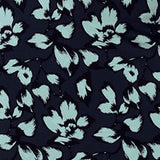 swatch of aqua blue floral print on navy blue dry touch jersey fabric, used by Australian and New Zealand women's clothing brand Leina & Fleur to make a collection of wrap dresses and work wear tops.