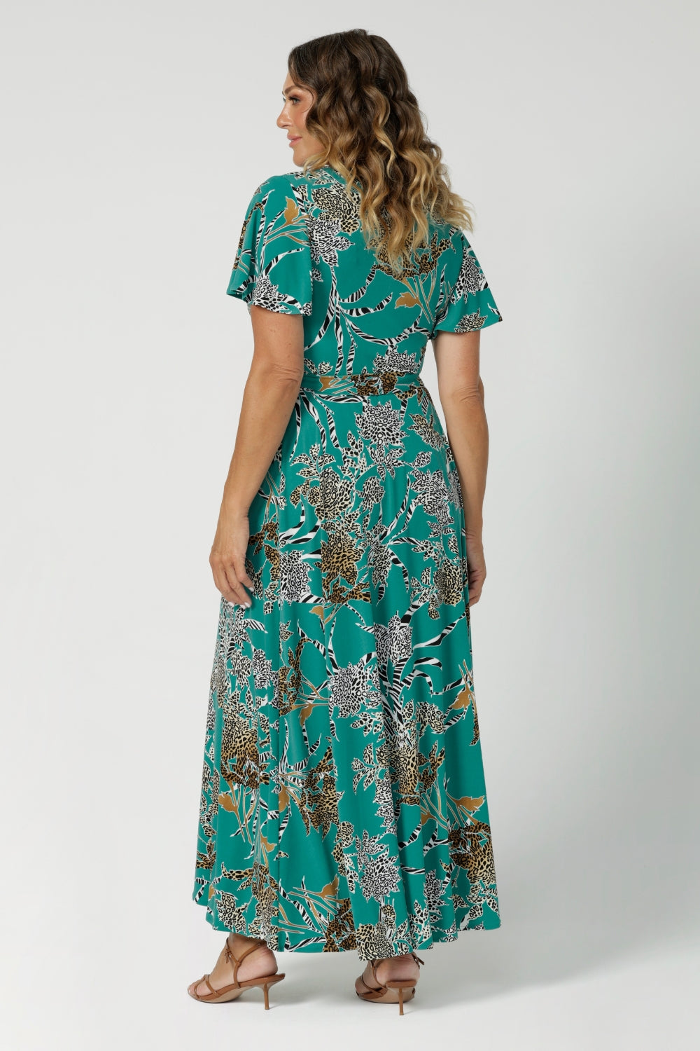 Back view image of jade coloured wrap dress, worn by size 12 model. Maxi dress blends style and comfort, ideal for off duty summer events. Made from dry-touch jersey fabric that is easy care and wrinkle resistant. Maxi length dress available now in sizes 8-24.