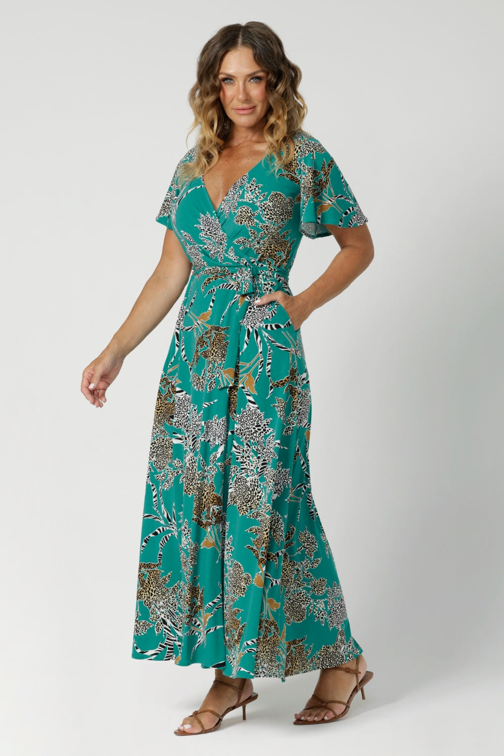 Summer wrap dress perfect blend of style and comfort, ideal for summer eventing. Made from jade coloured dry-touch jersey fabric, featuring abstract animal print details. Maxi length dress for off duty styling. Available in sizes 8-24.