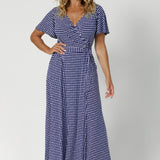 Size 12 woman wears A-line skirt that drapes beautifully, providing both comfort and movement. Maxi dress is designed with practical side pockets for practicality and functioning wrap adds to the dresses styling versatility. Leina & Fleur crafts dresses in sizes 8-24.