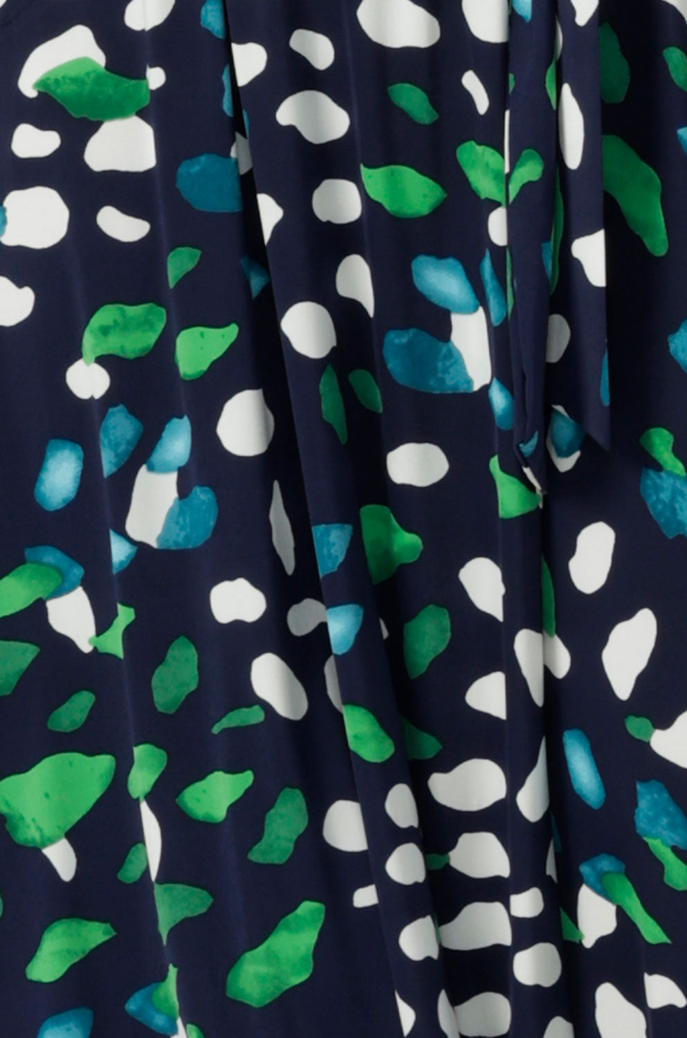 Fabric swatch of navy, green and white print dry touch jersey used to create a collection of workwear and wrap dresses for plus size and petite height women. All made in Australia by women's clothing brand, Leina & Fleur.