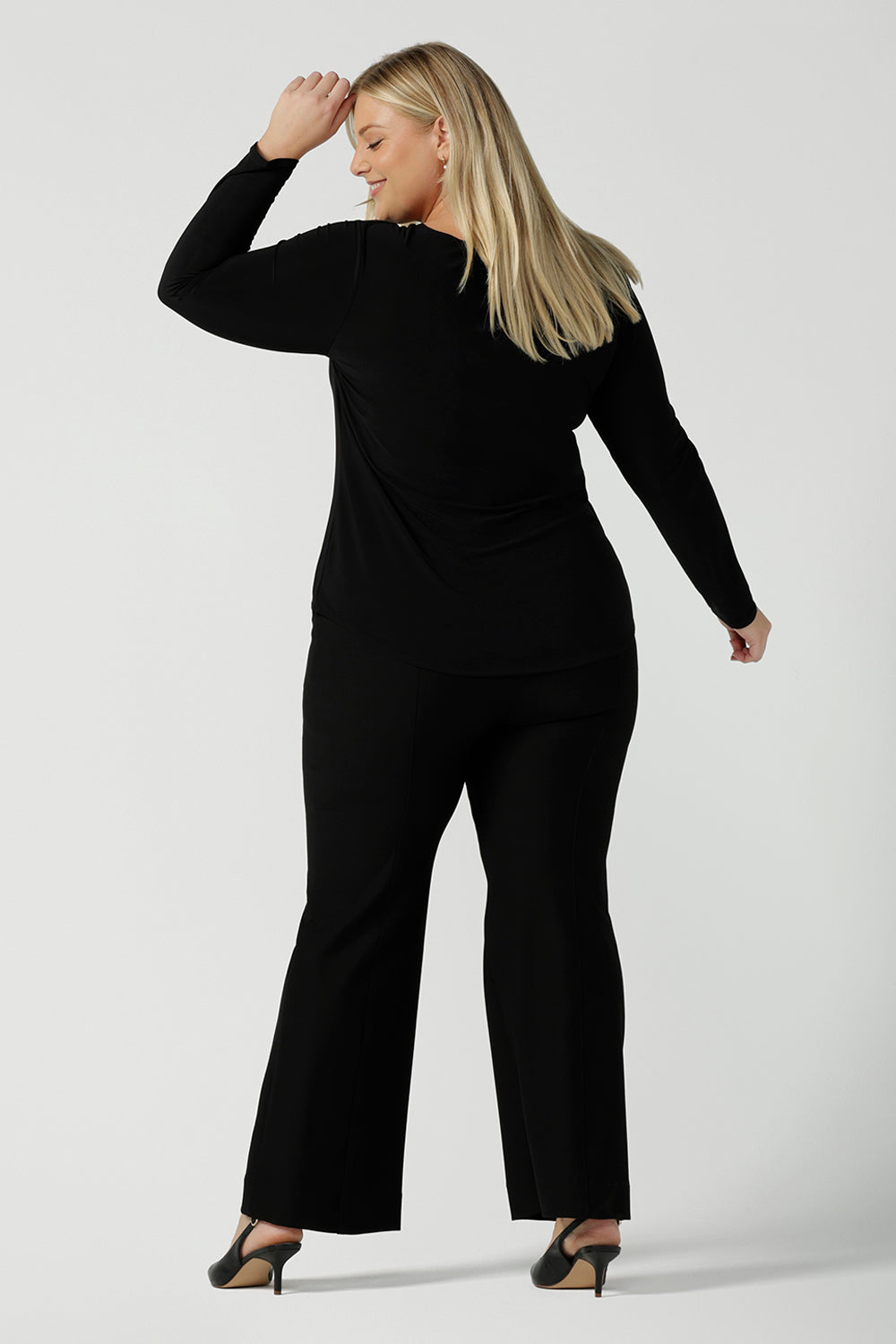 Back view of the Black Mason top in size 18. Made in Australia for women size 8 - 24. Long sleeve top made in easy care jersey. Made in Australia for women size 8 - 24. Styled bak with Brett pant in black.