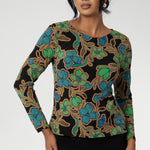 Size 10 woman wears a boat neck jersey top with long sleeves. In a floral print, this slim-fit jersey top sits well under jackets for workwear. 