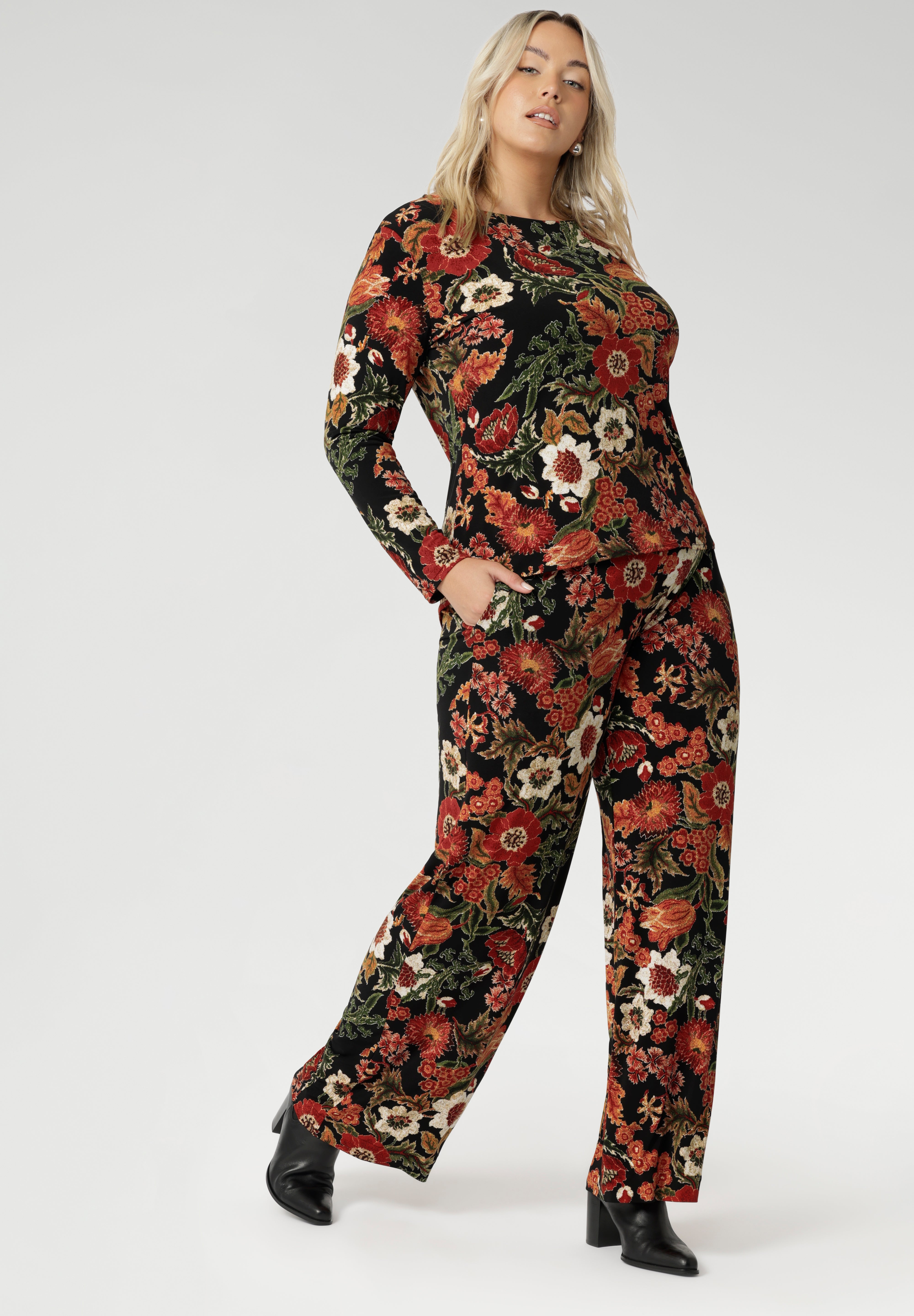 The Mason Top is an everyday essential, perfect for layering as the weather cools. With its chic boat neckline and clean, streamlined design, the Mason Top in Tapestry will quickly become your go-to piece for effortless style. Crafted from dry-touch jersey fabric, this top features a stunning floral Tapestry print on a black base, with rich shades of red, orange, pink, beige, and green. The fabric is stretchy, crease-resistant, and easy to care for, making it both practical and stylish.