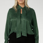 Crafted from suede touch Tencel that has a luxurious feel and drape. Proudly made in Australia in sizes 8-24. The Matisse Shirt in Deep Green is a pull-on style with a tie neckline, crafted from soft, fluid fabric. Blouson sleeves and buttoned cuffs add a polished finish. Matisse is a semi-fitted pull on style V-neckline shirt with extended neck ties, back pleats and bishop sleeves.