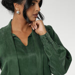 Crafted from suede touch Tencel that has a luxurious feel and drape. Proudly made in Australia in sizes 8-24. The Matisse Shirt in Deep Green is a pull-on style with a tie neckline, crafted from soft, fluid fabric. Blouson sleeves and buttoned cuffs add a polished finish. Matisse is a semi-fitted pull on style V-neckline shirt with extended neck ties, back pleats and bishop sleeves.