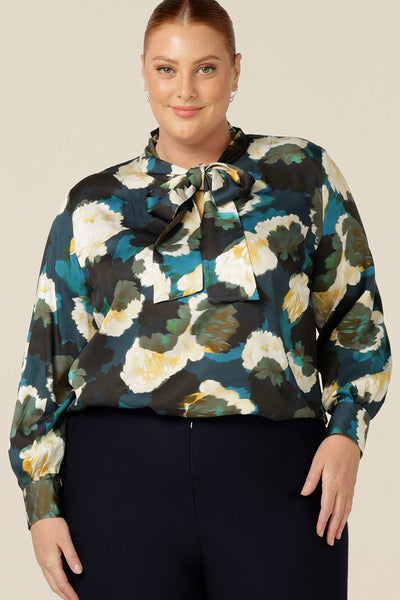 A luxe pull-on shirt in abstract floral print, the Matisse Shirt in Pom Pom has a V-neckline with pussy bow neck ties and long, bishop sleeves that blouson over fitted cuffs. Made in Australia by Australian and New Zealand women's clothing label, L&F, in sizes 8 to 24.