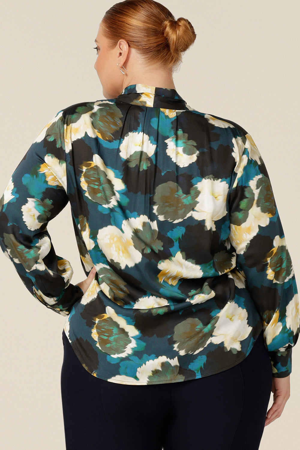 Back view of a luxe pull-on shirt in abstract floral print, the Matisse Shirt in Pom Pom with a V-neckline with pussy bow neck ties and long, bishop sleeves that blouson over fitted cuffs. Wear for work or as elegant evening wear. 