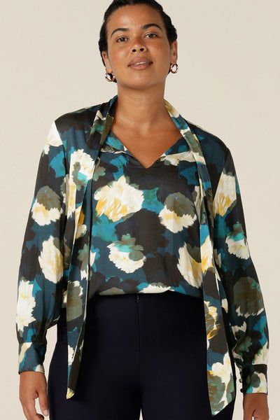 A luxe pull-on shirt in abstract floral print, the Matisse Shirt in Pom Pom has a V-neckline with pussy bow neck ties and long, bishop sleeves that blouson over fitted cuffs. Australian-made this elegant work wear shirt is available to shop in sizes 8 to 24.