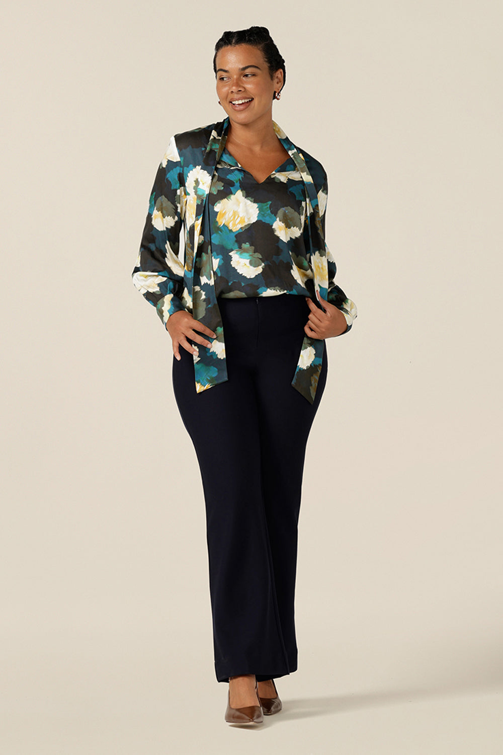 A luxe pull-on shirt in abstract floral print, the Matisse Shirt in Pom Pom has a V-neckline with pussy bow neck ties and long, bishop sleeves that blouson over fitted cuffs. Worn with flared leg, tailored pants in navy, this is an elegant workwear shirts.