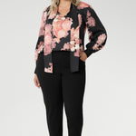 While the fabric offers no stretch, its fluid drape ensures a flattering, comfortable fit. Ideal for pairing with tailored separates or dressed down with denim, the Matisse Shirt brings timeless romance to your wardrobe. Plus size woman wears floral blouse tucked into her straight leg pants. 