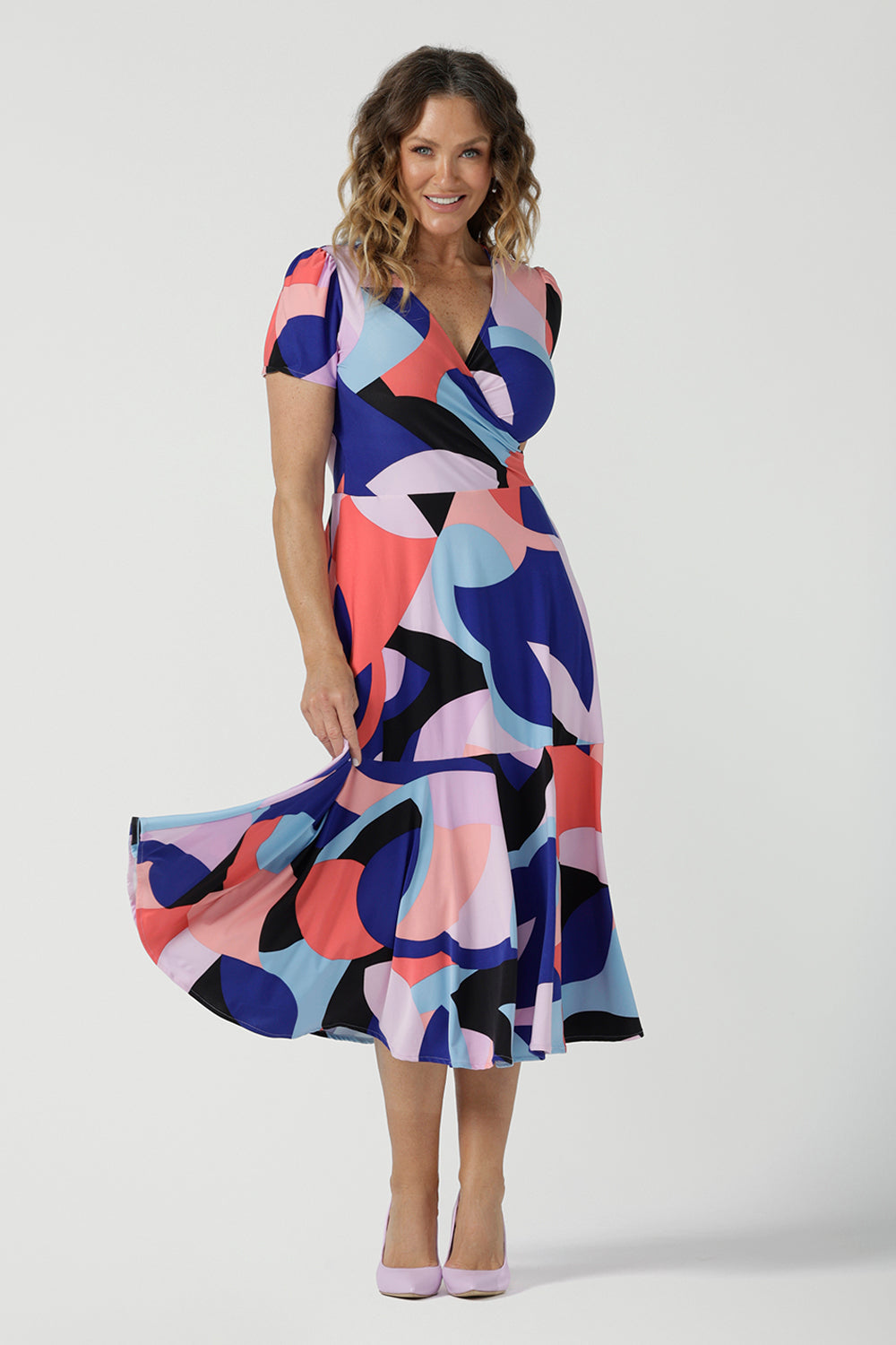 The Mavi Dress in Amalfi is a fixed wrap dress in midi length. A abstract print with a short sleeve. Based on our best selling Bettina dress, this style is great to take you from desk to dinner. Petite to plus size women size 8-24.