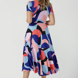 Back of The Mavi Dress in Amalfi is a fixed wrap dress in midi length. A abstract print with a short sleeve. Based on our best selling Bettina dress, this style is great to take you from desk to dinner. Petite to plus size women size 8-24.