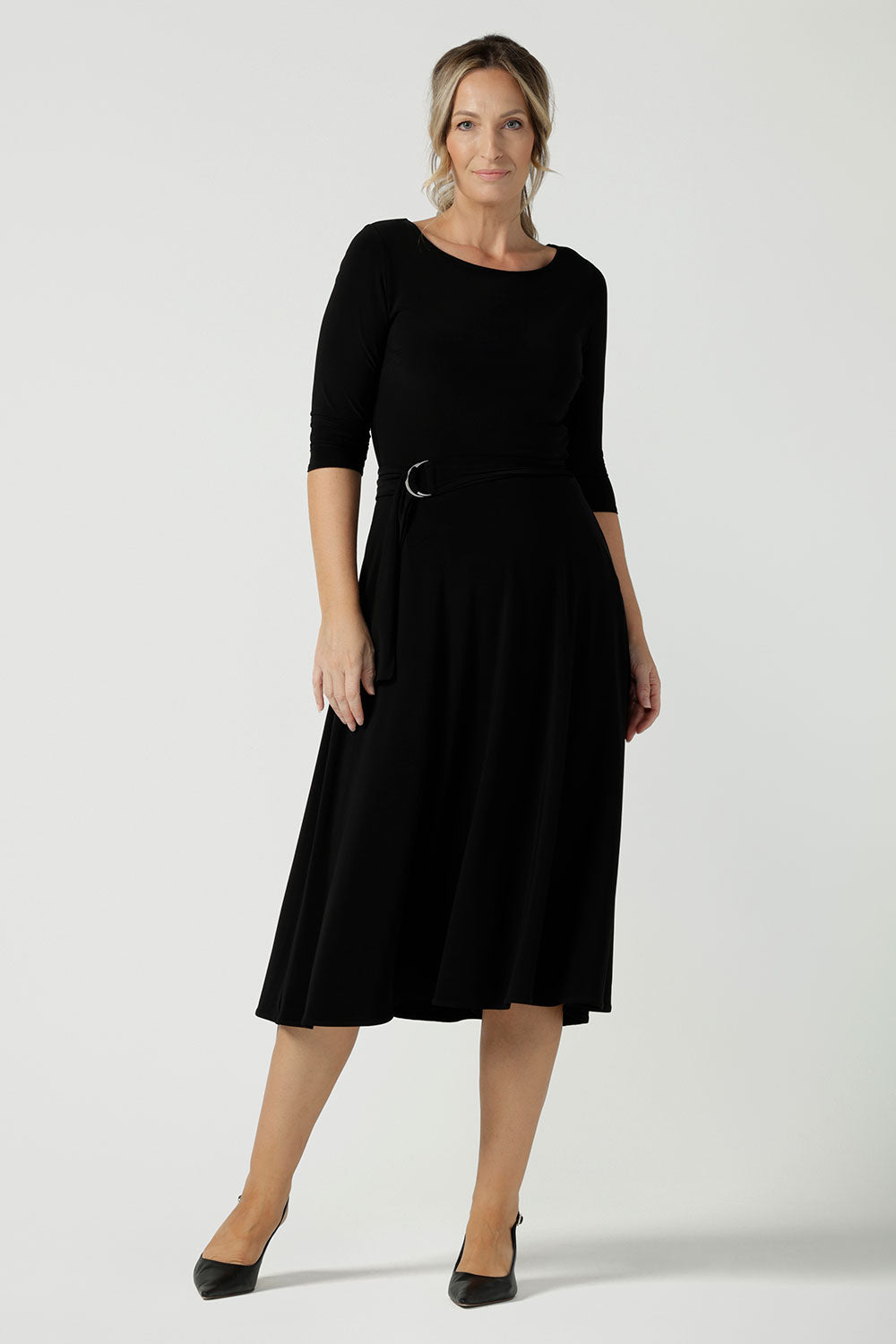 Size 10 woman wears the Melissa dress in black, a belted style with pockets and 3/4 sleeve with rounded boat neckline. Petite to plus size fashion made in Australia for women size 8 - 24.