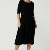 Size 10 woman wears the Melissa dress in black, a belted style with pockets and 3/4 sleeve with rounded boat neckline. Petite to plus size fashion made in Australia for women size 8 - 24.