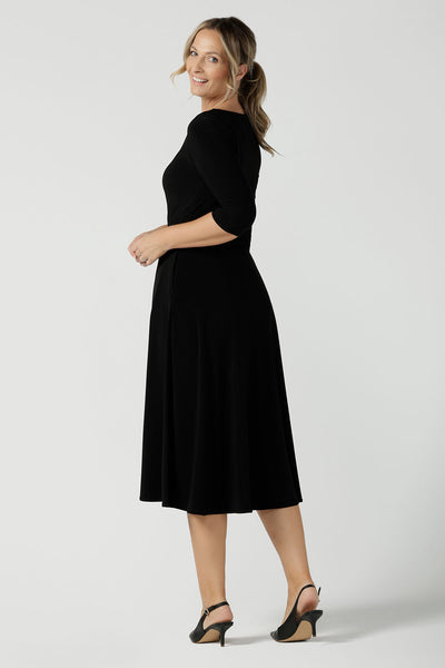 Back view of a size 10 woman wears the Melissa dress in black, a belted style with pockets and 3/4 sleeve with rounded boat neckline. Petite to plus size fashion made in Australia for women size 8 - 24.