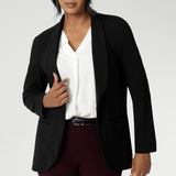 30 year old woman wears tailored black blazer made of soft stretch scuba crepe fabric. Easy care blazer is a staple for any wardrobe. Black work wear blazer provides the perfect blend of work wear and off-duty style. Australia made clothing brand Leina & Fleur. Shop Soft Suiting in sizes 8-24. 