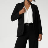 Leina & Fleur's model wearing black workwear blazer. Designed for modern professionals who value functionality and comfort. Woman's fashion brand Leina & Fleur stock soft suiting in sizes 8 to 24. Find this easy care work blazer and matching suit pants in plus size and petite sizes.