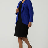 A size 10 model wears the Merit Blazer in Cobalt, a corporate casual blazer suit set made for women size 8-24. Styled back with matching Corbin Pant in Cobalt. Made in Australia for women size 8-24.