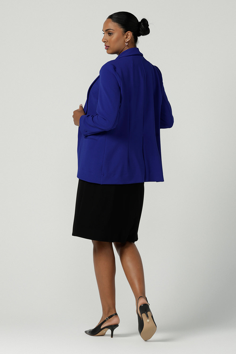 Back view of a size 10 model wears the Merit Blazer in Cobalt, a corporate casual blazer suit set made for women size 8-24.  . Made in Australia for women. Petite to plus size.