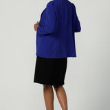 Back view of a size 10 model wears the Merit Blazer in Cobalt, a corporate casual blazer suit set made for women size 8-24.  . Made in Australia for women. Petite to plus size.