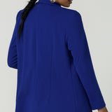 Back view of a size 10 model wears the Merit Blazer in Cobalt, a corporate casual blazer suit set made for women size 8-24. . Made in Australia for women. Petite to plus size.