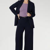 Size 10 women wearing a Navy Merit blazer with Scuba crepe and collar. It has functional patch pockets and tailored shawl collar. Stylish corporate casual wear for women. Made in Australia size 8 - 24.