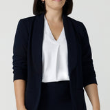 Size 10 women wearing a Navy Marit blazer with Scuba crepe and collar. It has functional patch pockets and tailored shawl collar. Stylish corporate casual wear for women. Made in Australia size 8 - 24. 