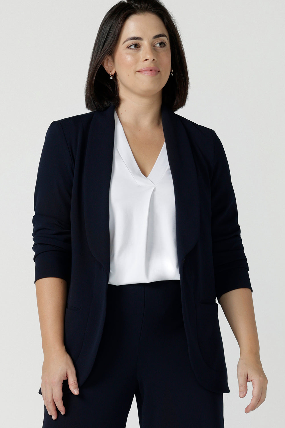 Size 10 women wearing a Navy Marit blazer with Scuba crepe and collar. It has functional patch pockets and tailored shawl collar. Stylish corporate casual wear for women. Made in Australia size 8 - 24. 