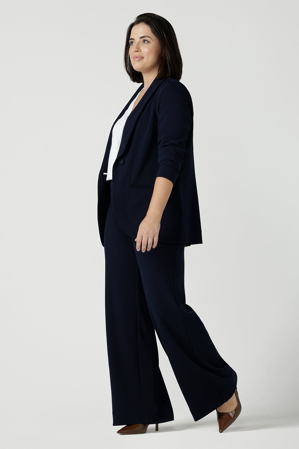 Size 10 women wearing a Navy Marit blazer with Scuba crepe and collar. It has functional patch pockets and tailored shawl collar. Stylish corporate casual wear for women. Made in Australia size 8 - 24.